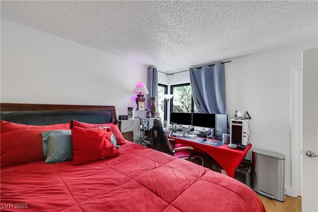4629 Denwood Dr, Las Vegas, NV 89147 - bedroom with a textured ceiling, an office area, and wood finished floors