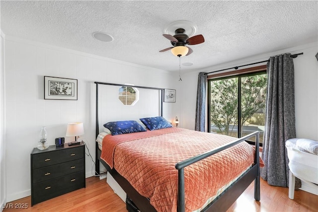 4629 Denwood Dr, Las Vegas, NV 89147 - bedroom featuring light wood-type flooring, a textured ceiling, and a ceiling fan