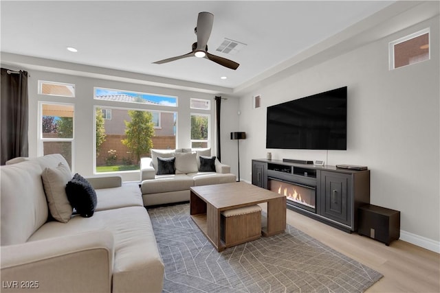 9604 Stoney Mesa Ct, Las Vegas, NV 89139 - living area featuring recessed lighting, a ceiling fan, baseboards, a glass covered fireplace, and light wood-type flooring