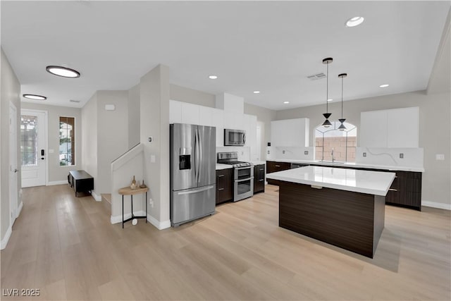 9604 Stoney Mesa Ct, Las Vegas, NV 89139 - kitchen with appliances with stainless steel finishes, light countertops, modern cabinets, a kitchen island, and baseboards