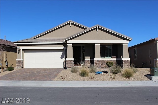4108 Fairywren Dr, North Las Vegas, NV 89031 - craftsman inspired home featuring stone siding, stucco siding, driveway, a porch, and an attached garage