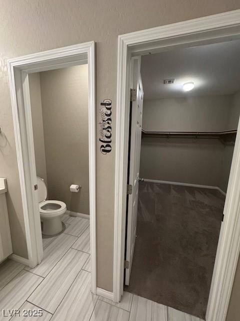 4108 Fairywren Dr, North Las Vegas, NV 89031 - bathroom featuring toilet, baseboards, and vanity