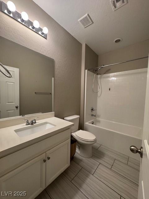 4108 Fairywren Dr, North Las Vegas, NV 89031 - full bathroom featuring vanity, toilet, bathing tub / shower combination, and a textured wall