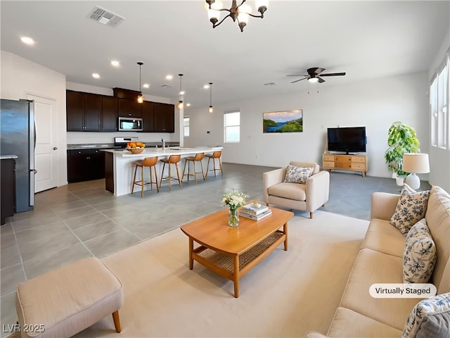 6918 Dandelion Park Ave, Las Vegas, NV 89113 - living room featuring light tile patterned flooring, a chandelier, ceiling fan, and recessed lighting
