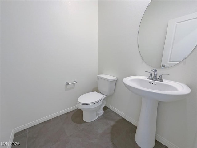 6918 Dandelion Park Ave, Las Vegas, NV 89113 - half bathroom with toilet, tile patterned flooring, baseboards, and a sink