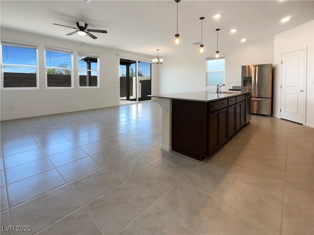 6918 Dandelion Park Ave, Las Vegas, NV 89113 - kitchen with stainless steel fridge, open floor plan, a sink, healthy amount of natural light, and recessed lighting
