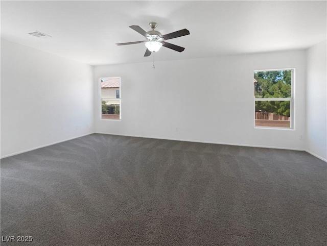 8253 Pearl Oasis Ct, Las Vegas, NV 89139 - spare room featuring plenty of natural light, dark carpet, a ceiling fan, and baseboards