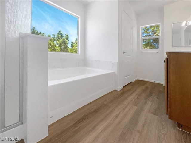 8253 Pearl Oasis Ct, Las Vegas, NV 89139 - full bath with vanity, wood finished floors, a garden tub, and plenty of natural light
