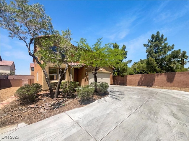 8253 Pearl Oasis Ct, Las Vegas, NV 89139 - view of property hidden behind natural elements featuring stucco siding, driveway, a tile roof, and an attached garage