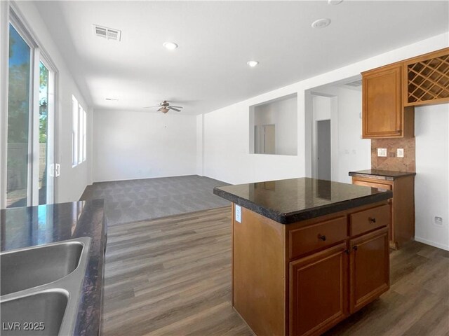 8253 Pearl Oasis Ct, Las Vegas, NV 89139 - kitchen with wood finished floors, a sink, a ceiling fan, brown cabinets, and recessed lighting