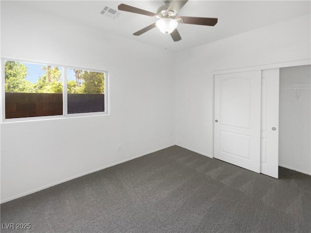 8253 Pearl Oasis Ct, Las Vegas, NV 89139 - unfurnished bedroom with dark carpet, a closet, ceiling fan, and baseboards