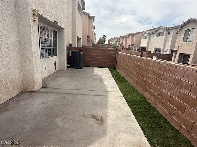 2025 Cary Grant Ct, Las Vegas, NV 89142 - fenced backyard featuring central air condition unit, a residential view, and a patio area