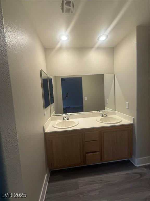 2025 Cary Grant Ct, Las Vegas, NV 89142 - bathroom featuring double vanity, wood finished floors, and baseboards