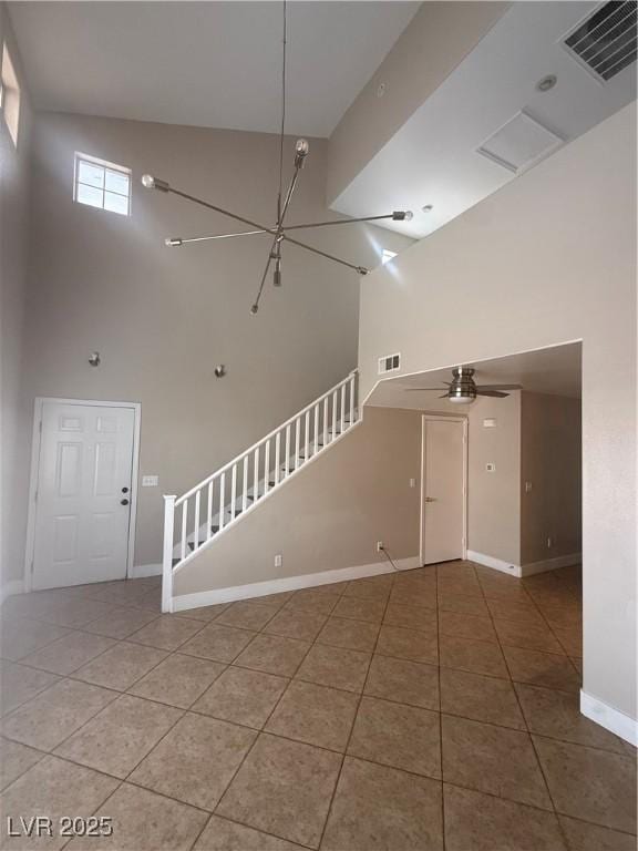 2025 Cary Grant Ct, Las Vegas, NV 89142 - empty room featuring a towering ceiling, stairway, tile patterned floors, baseboards, and ceiling fan