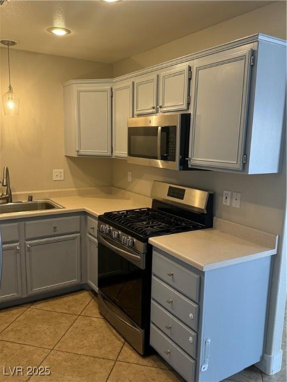 2025 Cary Grant Ct, Las Vegas, NV 89142 - kitchen featuring stainless steel appliances, a sink, gray cabinets, light countertops, and light tile patterned floors
