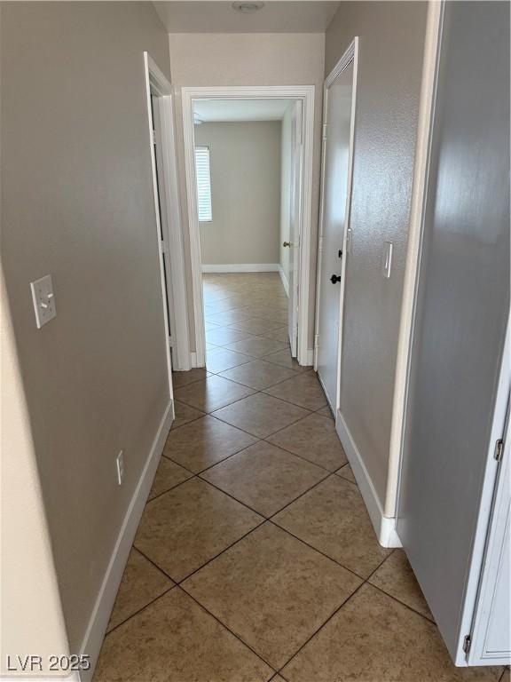 2025 Cary Grant Ct, Las Vegas, NV 89142 - hallway featuring light tile patterned floors and baseboards
