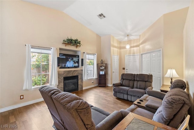 9329 Mountain Cliffs Ave, Las Vegas, NV 89129 - living area with high vaulted ceiling, a fireplace, wood finished floors, and baseboards