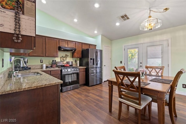 9329 Mountain Cliffs Ave, Las Vegas, NV 89129 - kitchen featuring stainless steel appliances, a sink, range hood, vaulted ceiling, and dark wood-style flooring