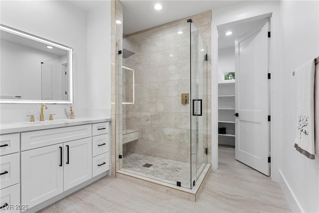 2309 Prometheus Ct, Henderson, NV 89074 - bathroom featuring vanity, a stall shower, recessed lighting, baseboards, and wood finished floors