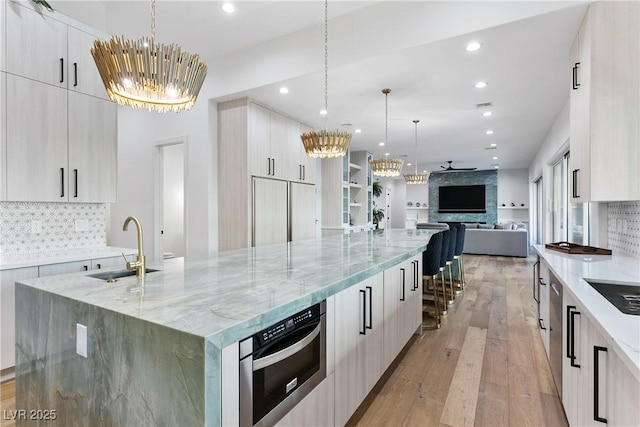 2309 Prometheus Ct, Henderson, NV 89074 - kitchen featuring modern cabinets, a chandelier, a sink, and recessed lighting
