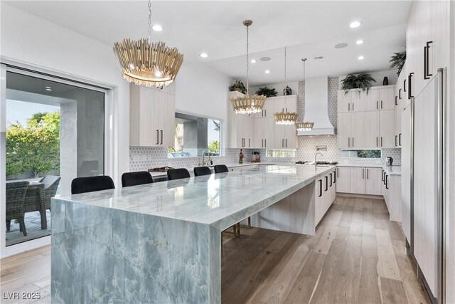 2309 Prometheus Ct, Henderson, NV 89074 - kitchen with custom range hood, a chandelier, modern cabinets, and recessed lighting