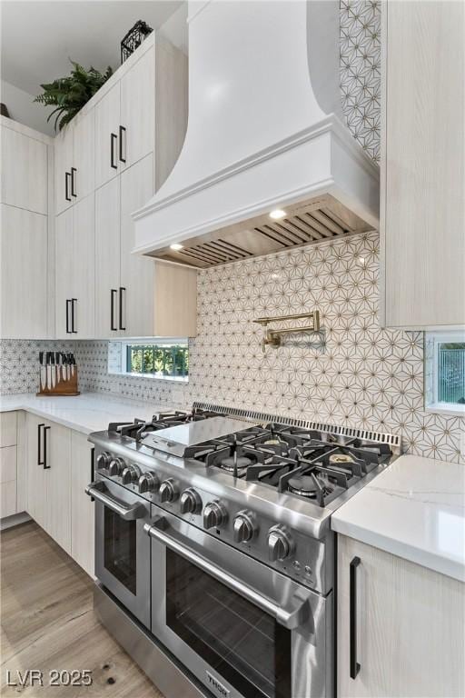 2309 Prometheus Ct, Henderson, NV 89074 - kitchen with double oven range, custom range hood, decorative backsplash, and light wood-style floors