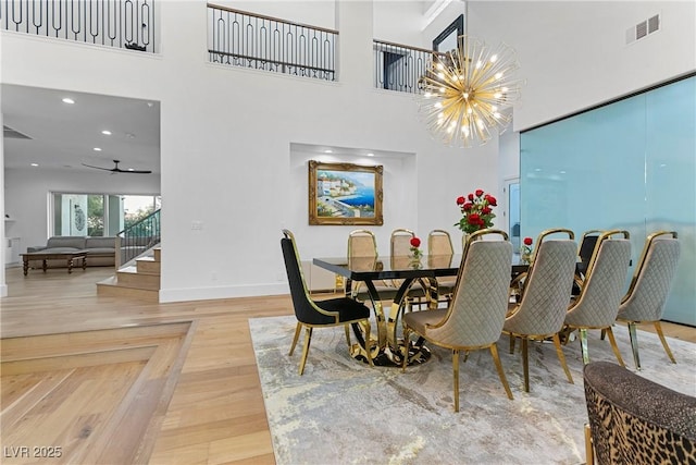 2309 Prometheus Ct, Henderson, NV 89074 - dining area featuring baseboards, a chandelier, stairway, a towering ceiling, and recessed lighting