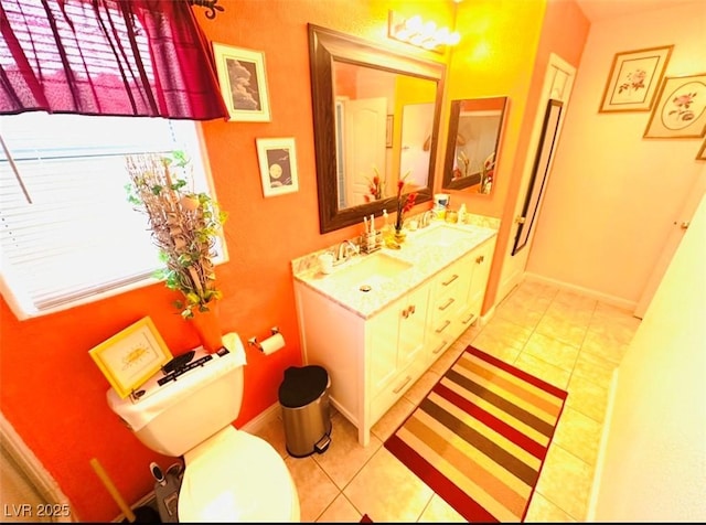 8156 Blue Hope Diamond Ln, Las Vegas, NV 89139 - bathroom featuring double vanity, toilet, tile patterned flooring, and baseboards