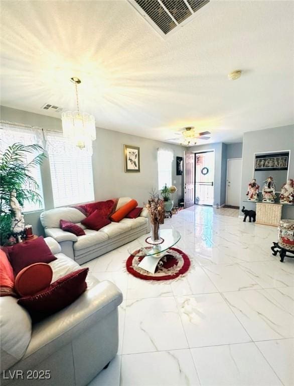 8156 Blue Hope Diamond Ln, Las Vegas, NV 89139 - living room featuring marble finish flooring and a chandelier