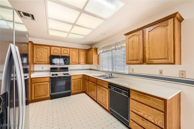 3104 Hayden Ct, Las Vegas, NV 89134 - kitchen with black appliances, light flooring, light countertops, and brown cabinetry