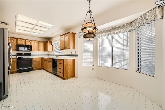3104 Hayden Ct, Las Vegas, NV 89134 - kitchen with stove, black microwave, freestanding refrigerator, wine cooler, and light countertops