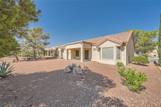 3104 Hayden Ct, Las Vegas, NV 89134 - rear view of house with a tiled roof and stucco siding