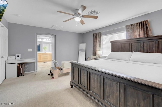 7937 Granite Walk Ave, Las Vegas, NV 89178 - bedroom with light colored carpet, multiple windows, ensuite bath, and ceiling fan