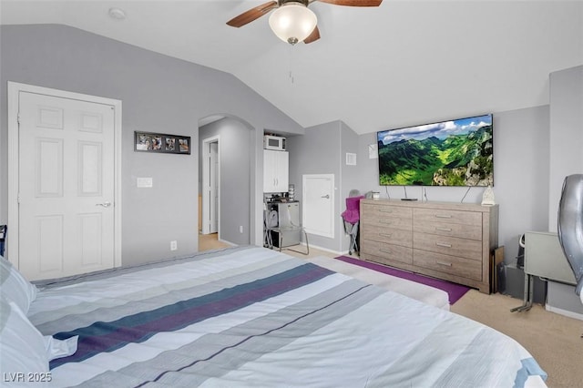 7937 Granite Walk Ave, Las Vegas, NV 89178 - bedroom with vaulted ceiling, light carpet, arched walkways, and a ceiling fan