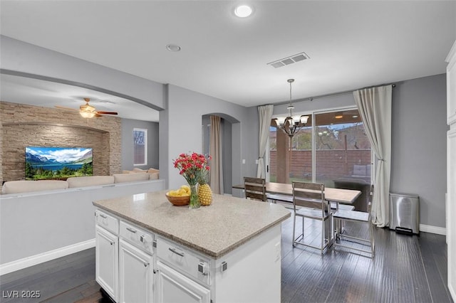 7937 Granite Walk Ave, Las Vegas, NV 89178 - kitchen featuring arched walkways, a chandelier, baseboards, white cabinetry, and recessed lighting