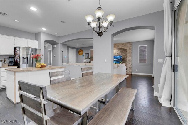 7937 Granite Walk Ave, Las Vegas, NV 89178 - dining area featuring arched walkways, dark wood finished floors, a chandelier, baseboards, and recessed lighting