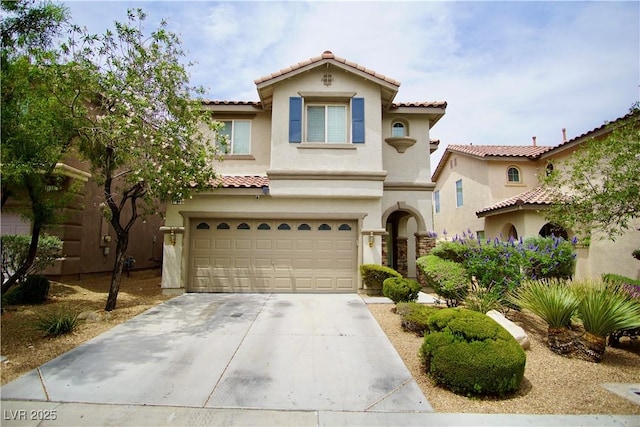 9144 Clear Sky Ave, Las Vegas, NV 89178 - mediterranean / spanish-style home featuring a tiled roof, concrete driveway, stucco siding, and a garage