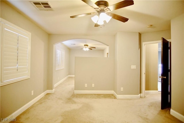 9144 Clear Sky Ave, Las Vegas, NV 89178 - spare room with arched walkways, a ceiling fan, light colored carpet, and baseboards