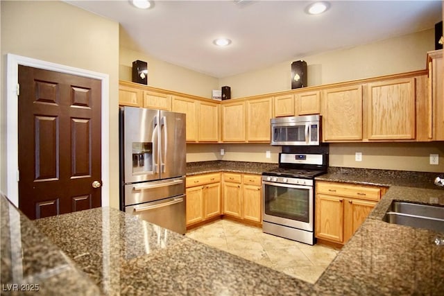 9144 Clear Sky Ave, Las Vegas, NV 89178 - kitchen featuring stainless steel appliances, light brown cabinets, dark stone countertops, a sink, and recessed lighting