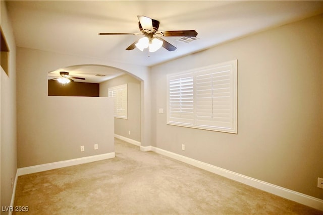 9144 Clear Sky Ave, Las Vegas, NV 89178 - spare room featuring ceiling fan, arched walkways, light carpet, and baseboards