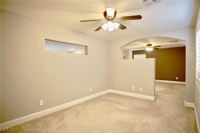 9144 Clear Sky Ave, Las Vegas, NV 89178 - empty room with a ceiling fan, arched walkways, light carpet, and baseboards