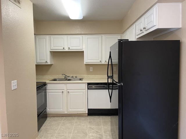 3151 Soaring Gulls Dr Unit 2147, Las Vegas, NV 89128 - kitchen featuring dishwasher, freestanding refrigerator, a sink, range, and white cabinetry