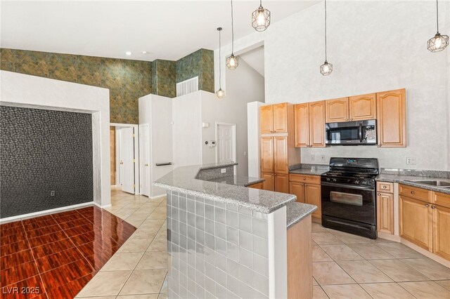 9688 Meeks Bay Ave, Las Vegas, NV 89148 - kitchen with black gas range oven, high vaulted ceiling, light tile patterned floors, a kitchen island, and hanging light fixtures