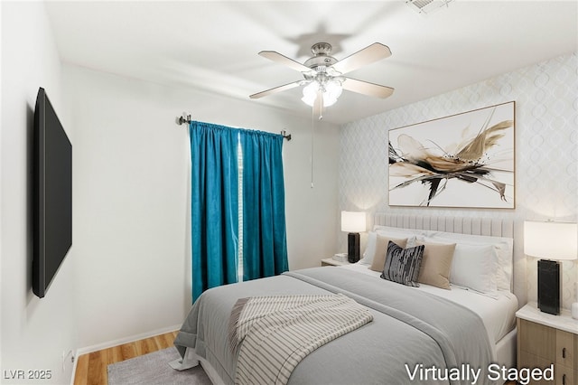 9688 Meeks Bay Ave, Las Vegas, NV 89148 - bedroom with wood finished floors, wallpapered walls, baseboards, and ceiling fan