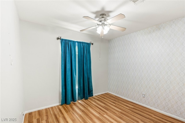 9688 Meeks Bay Ave, Las Vegas, NV 89148 - unfurnished room featuring light wood-style flooring, wallpapered walls, baseboards, and a ceiling fan