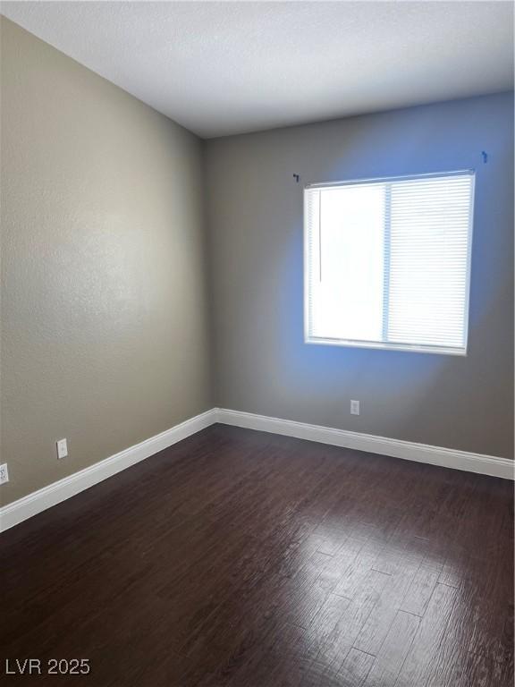 5217 Yellow Dawn Ct, Las Vegas, NV 89130 - spare room featuring dark wood finished floors and baseboards