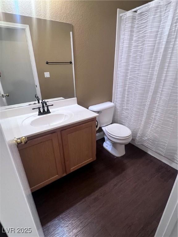 5217 Yellow Dawn Ct, Las Vegas, NV 89130 - full bath featuring toilet, vanity, wood finished floors, and curtained shower