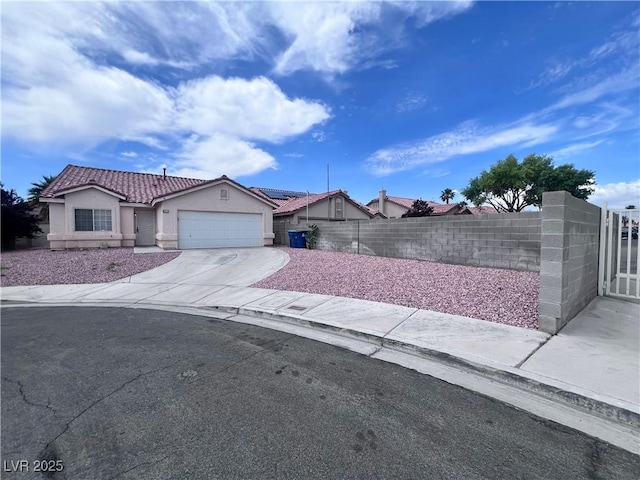 5217 Yellow Dawn Ct, Las Vegas, NV 89130 - view of front of home with stucco siding, driveway, an attached garage, and a tiled roof