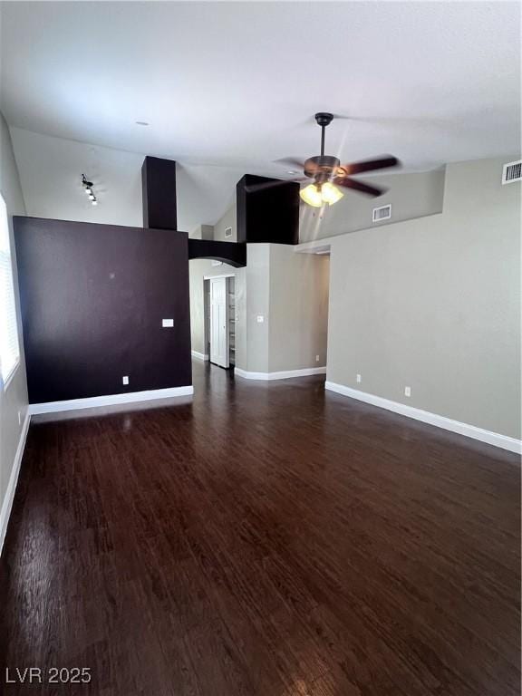 5217 Yellow Dawn Ct, Las Vegas, NV 89130 - unfurnished living room featuring a ceiling fan, dark wood-style flooring, baseboards, and lofted ceiling