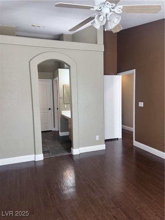 5217 Yellow Dawn Ct, Las Vegas, NV 89130 - unfurnished bedroom with arched walkways, wood finished floors, baseboards, and ceiling fan